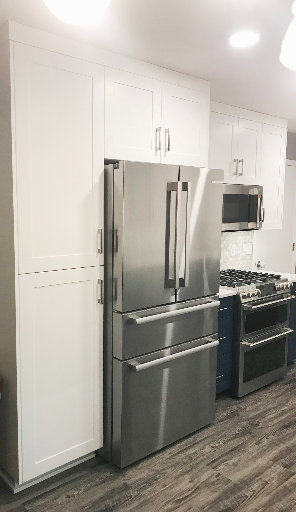 Dark Blue Lower Cabinets With White Upper Cabinets Kitchen Remodel by BAJCO Construction project photo 8