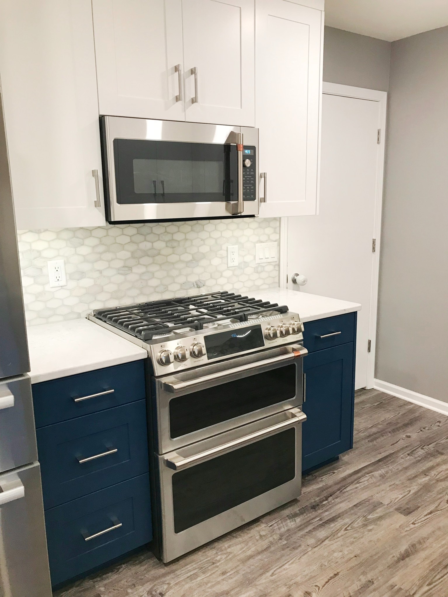 Dark Blue Lower Cabinets With White Upper Cabinets Kitchen Remodel by BAJCO Construction project photo 7
